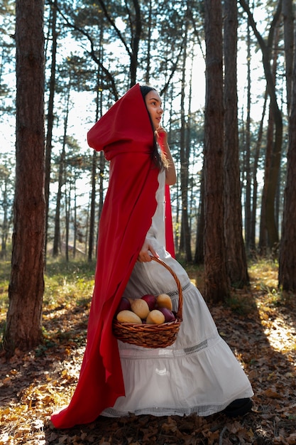 Little red riding hood with wooden basket with goodies