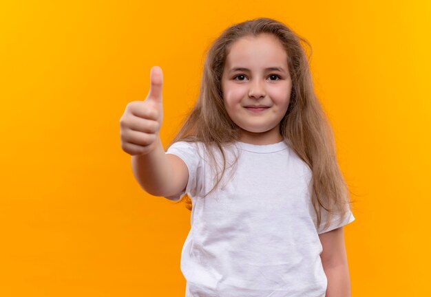 little school girl wearing white t-shirt her thumb up on isolated orange wall