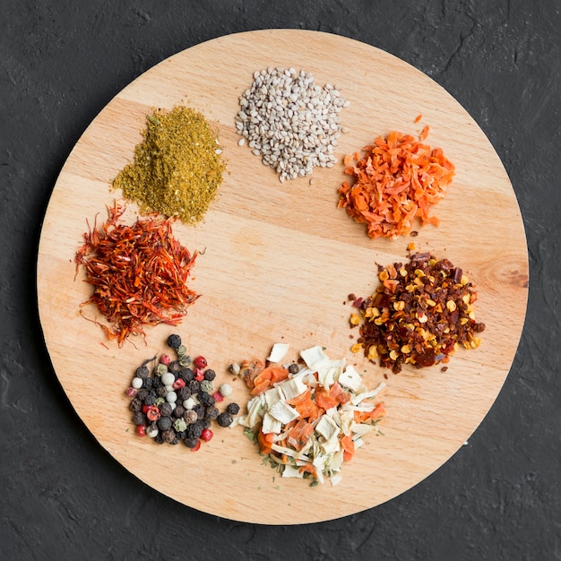 Little spice piles on wooden tray