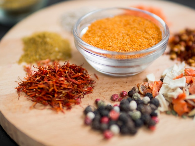 Little spice piles on wooden tray