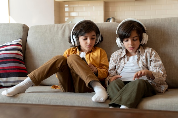 Little twins playing on their tablet