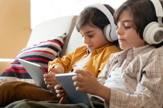 Little twins playing on their tablet