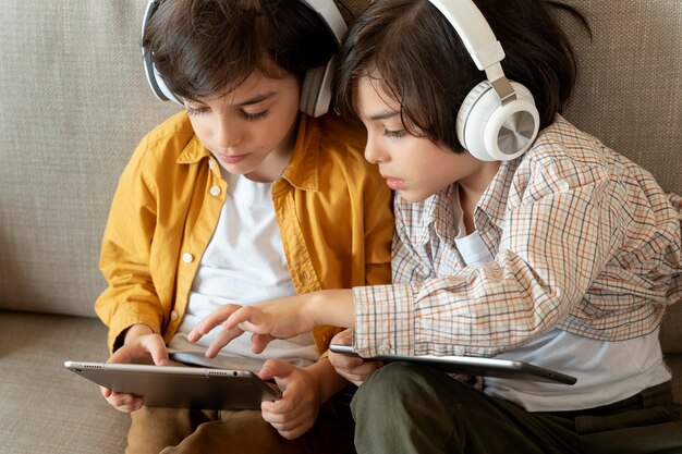 Little twins playing on their tablet