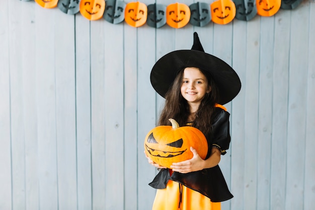 Little witch smiling at Halloween party