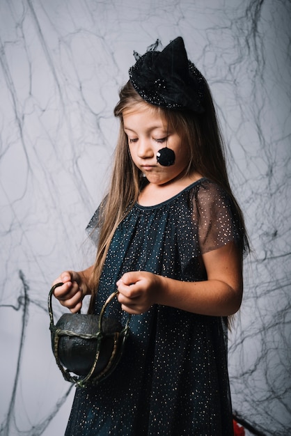 Free Photo little witch with cauldron