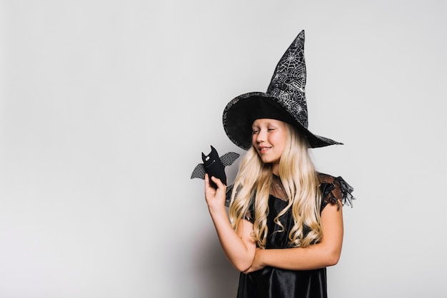 Free photo little witch with toy bat