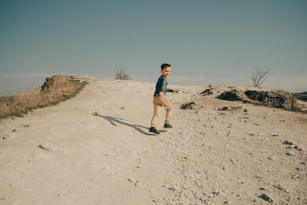 Little young caucasian boy in nature, childhood