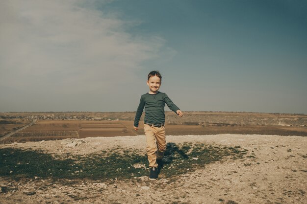 Little young caucasian boy in nature, childhood