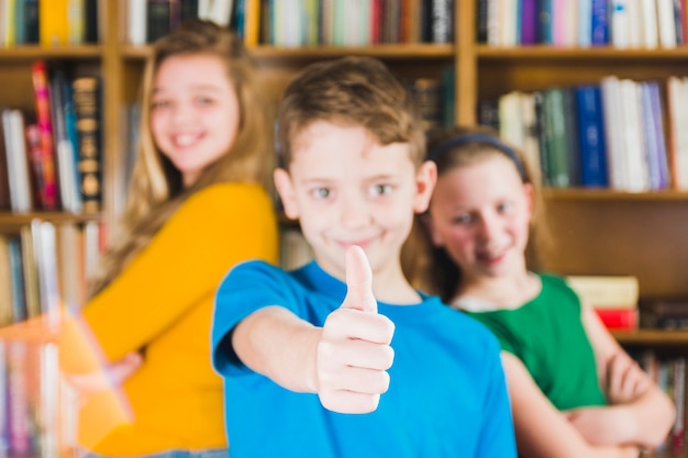 Free photo lively kids standing in library