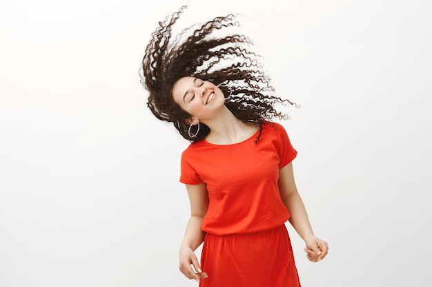 Living life to fullest. Happy positive attractive woman in stylish red dress