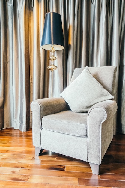 Free Photo living room with wooden floor and a grey armchair