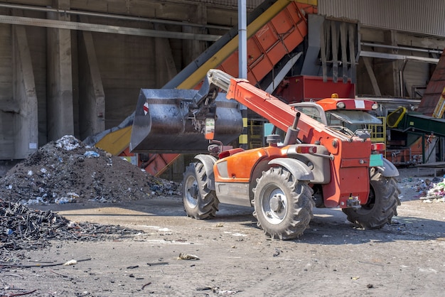 Free Photo loader transporting soil and waste materials at a waste treatment plant