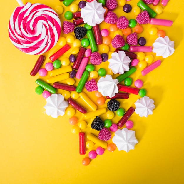 Free photo lollipop and sweets on yellow background