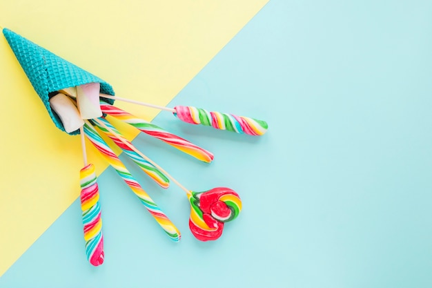 Lollipops and marshmallows in blue cone