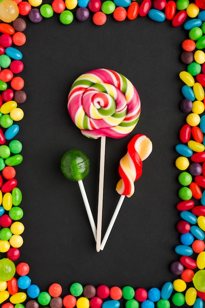 Lollipops with delicious sweets frame