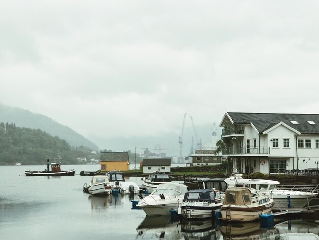 Lonely boats stand on the pierce covered with fog