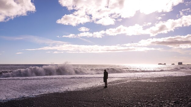 A lonely man standing at the beach