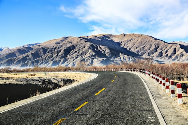 Lonely road with mountains on the horizon