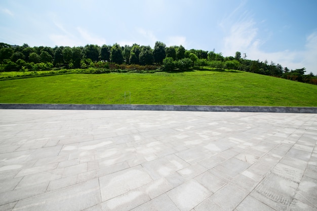 long empty footpath in modern city square with skyline