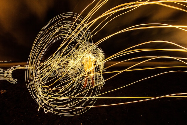 Long exposure shot of a man surrounded by light circles