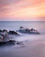 Free photo long exposure shot of the seascape in guernsey during a sunset