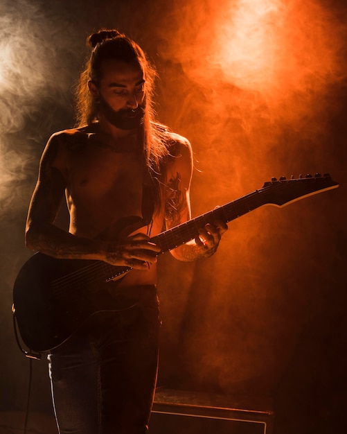 Free photo long hair guitar guy tapping chords