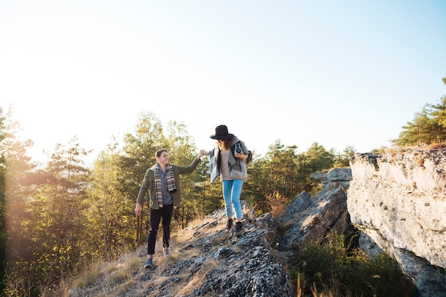 Long shot adult couple in the mountains