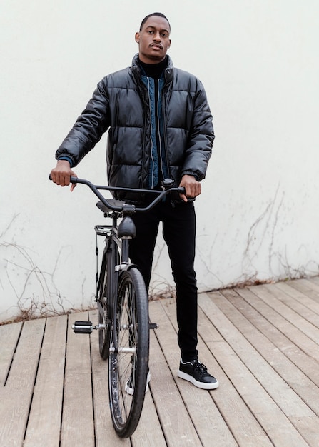 Long shot of adult make and his bicycle