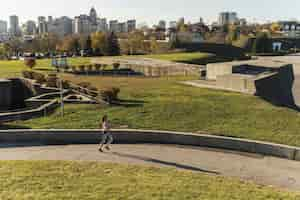 Free photo long shot athlete jogging in the park