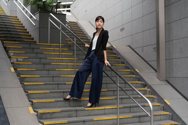 Long shot of beautiful business woman on stairs