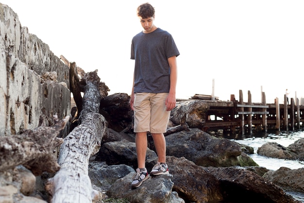 Free photo long shot of boy relaxing at sea