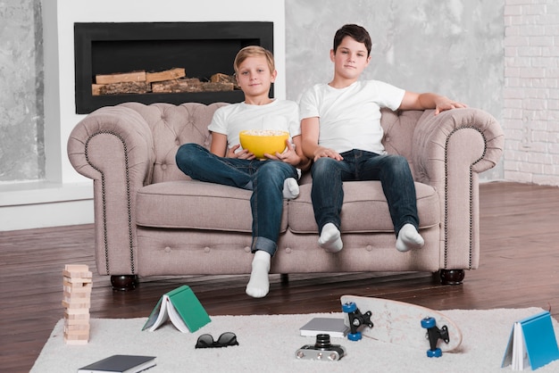 Long shot of boys sitting on couch