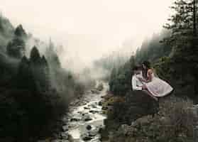 Free photo long shot couple levitating in nature