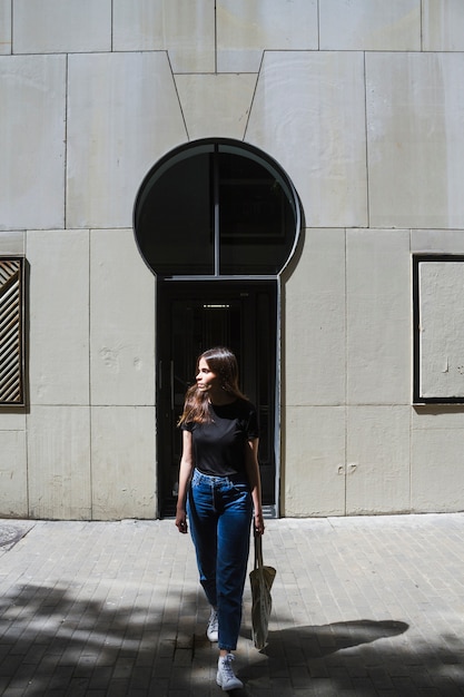 Free Photo long shot fashion woman holding a shopping bag