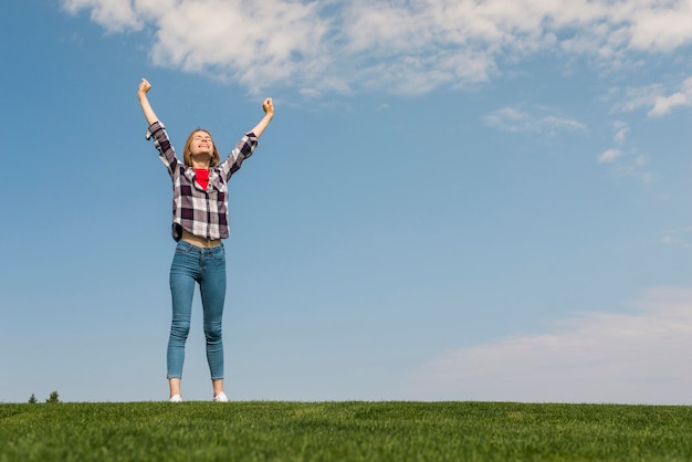 Long shot girl being happy in nature