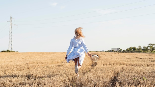 Free Photo long shot girl running in a field