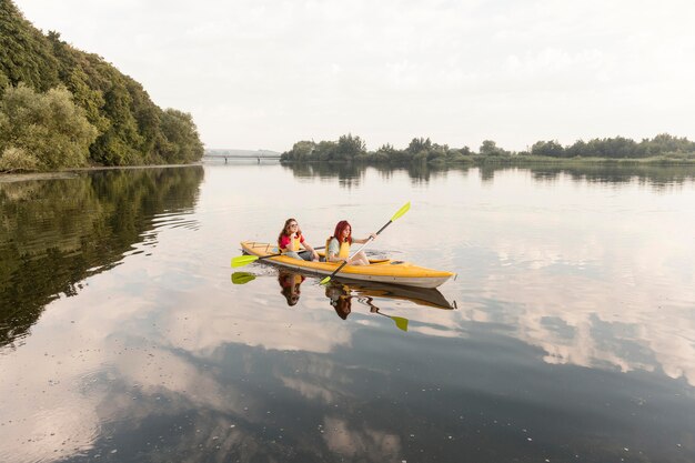 Long shot girls rowing in kayak