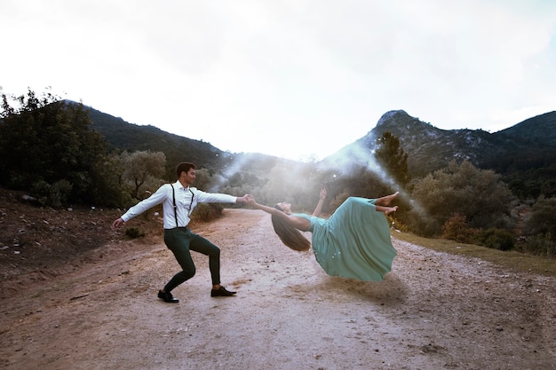 Free photo long shot man holding levitating woman