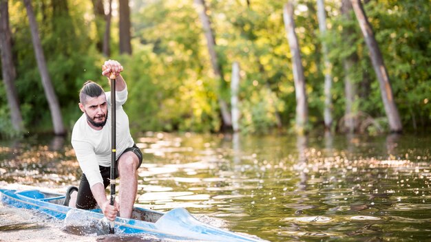 Long shot man paddling