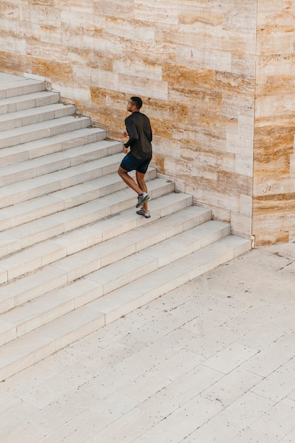 Free Photo long shot man running on stairs