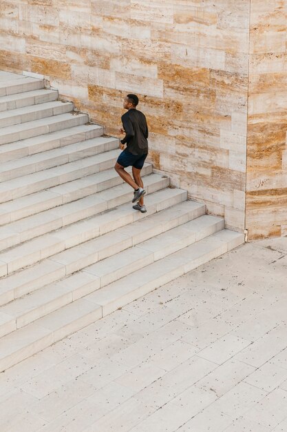 Long shot man running on stairs