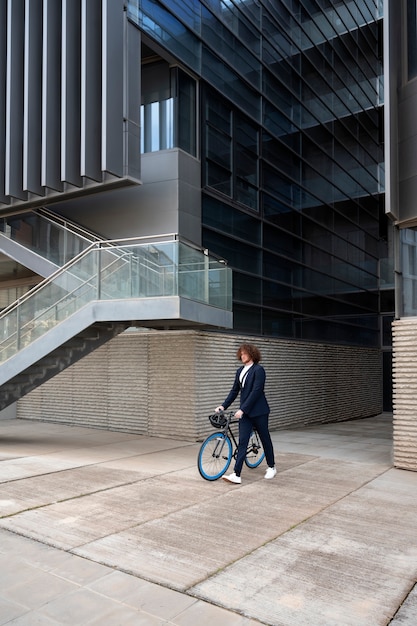 Free Photo long shot man with bicycle going to job