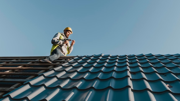 Long shot man working on roof