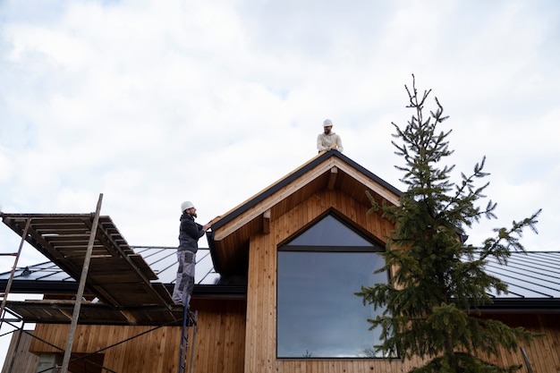 Free Photo long shot men working together on roof