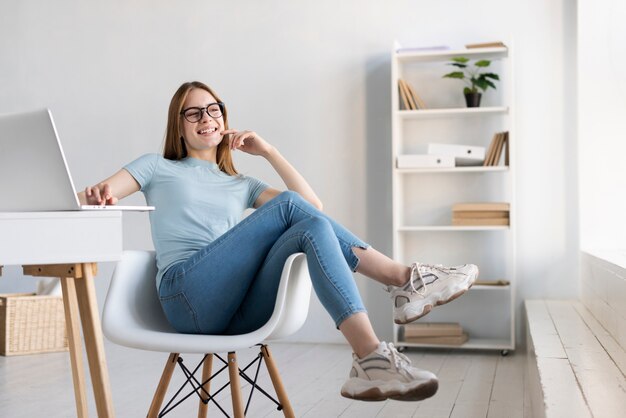 Long shot modern woman relaxing on her chair