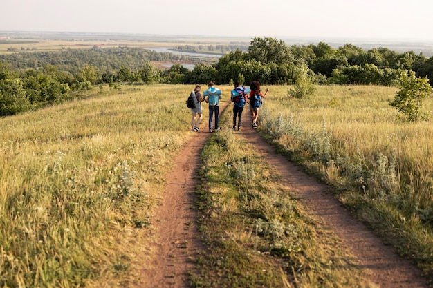 Free photo long shot people walking in nature