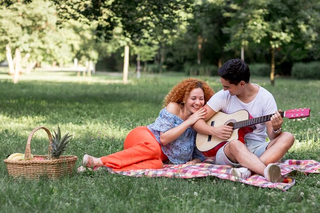 Long shot of playful couple in the park