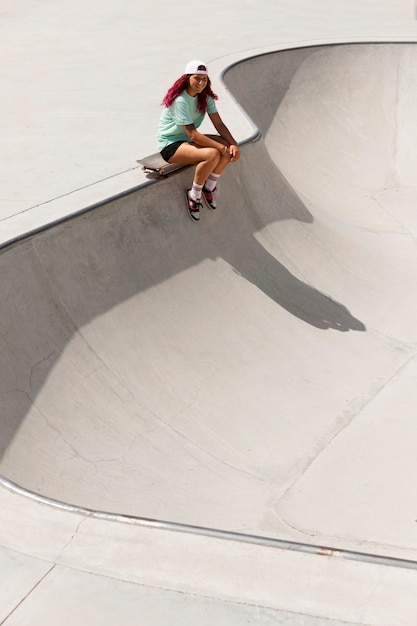 Long shot skater with board outside