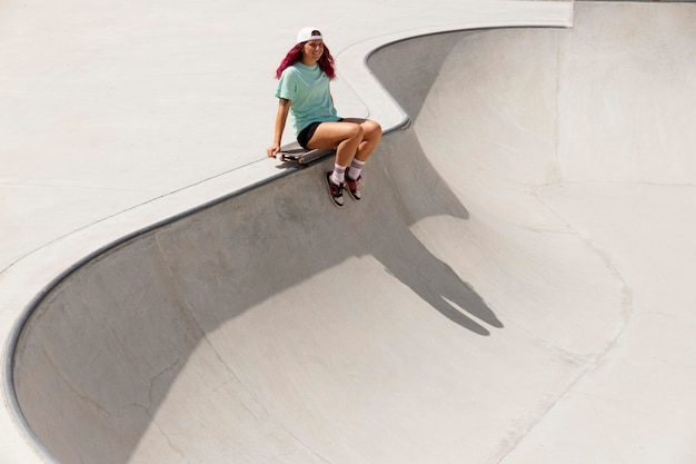 Long shot skater with board in park