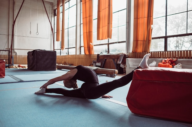 Free Photo long shot  woman exercising for gymnastics olympics